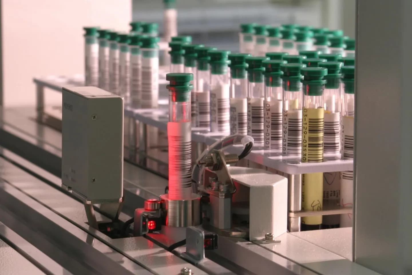 Barcoded test tubes moving through an automated laboratory system
