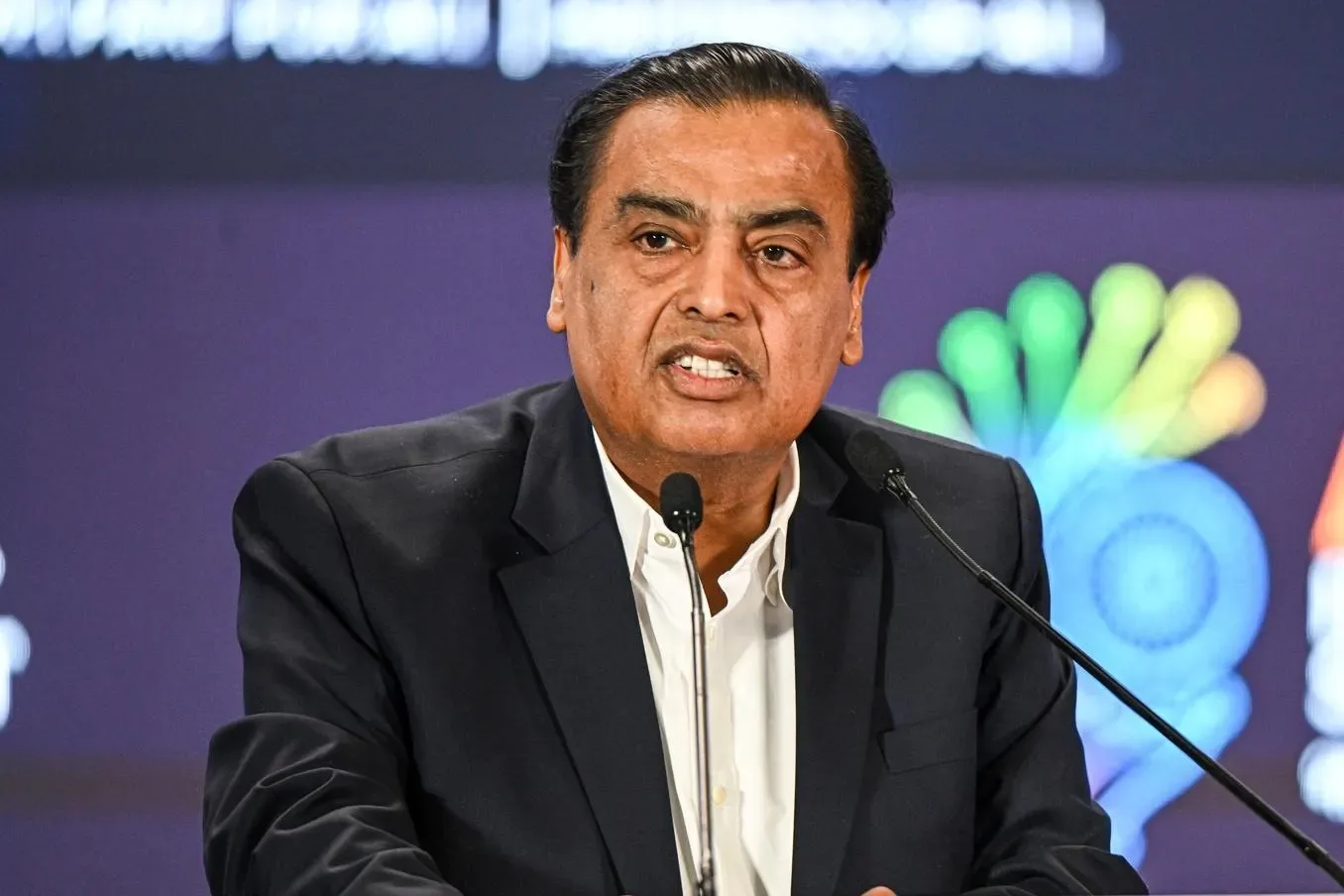 Mukesh Ambani, chairman of Reliance Industries, speaking at a podium
