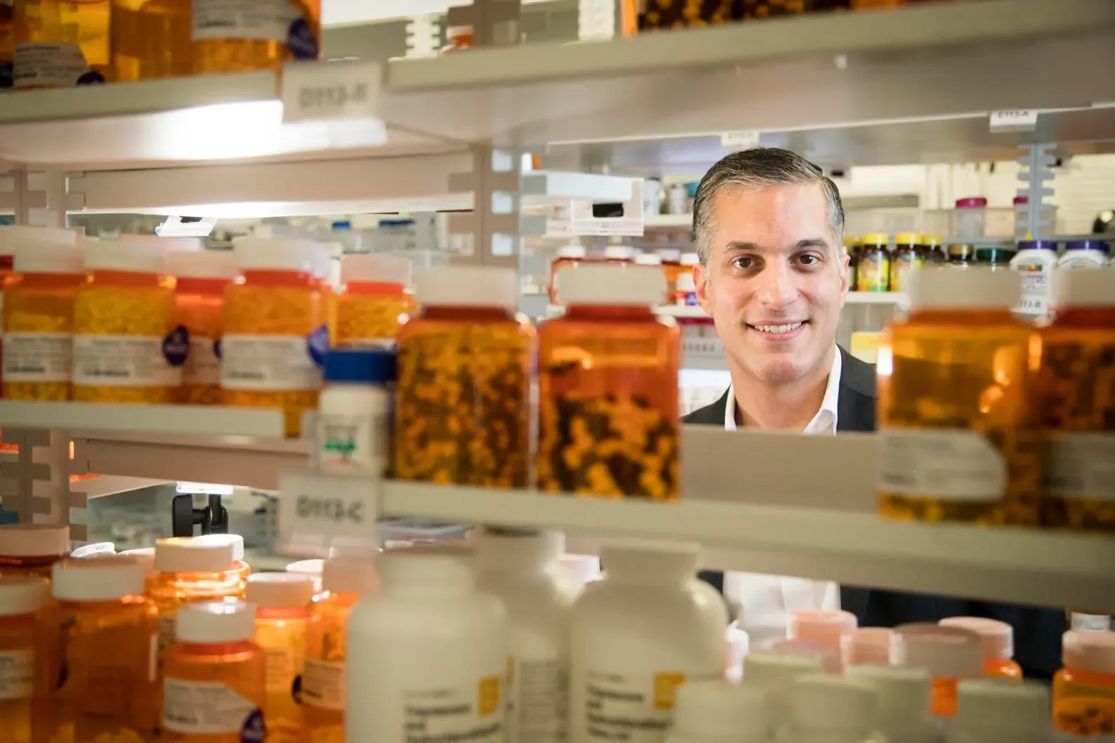 Shaun Noorian, founder of Empower Pharmacy, among shelves of pharmacy supplies