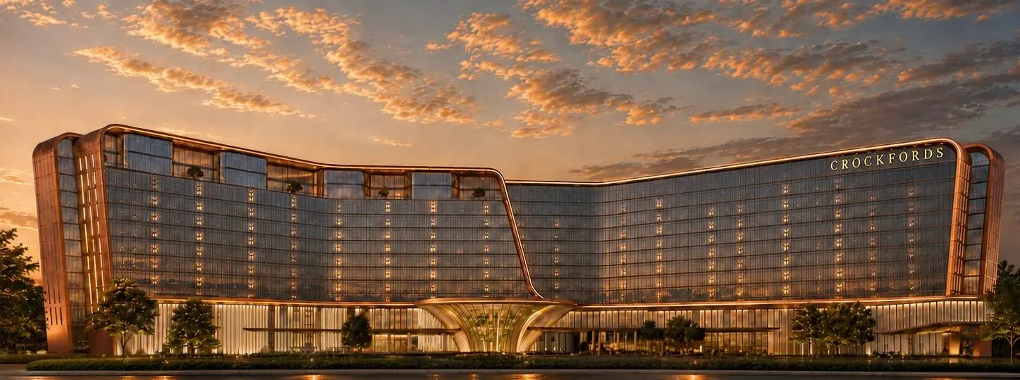 Rendering of the Crockfords hotel tower at Resorts World New York City glowing at dusk