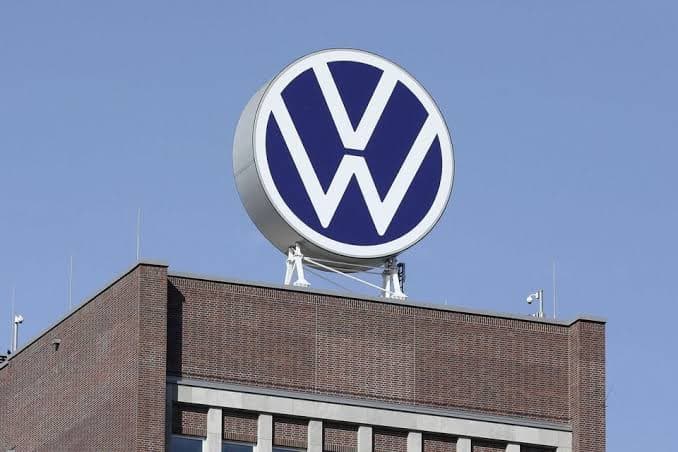 A Volkswagen logo mounted on top of a company building