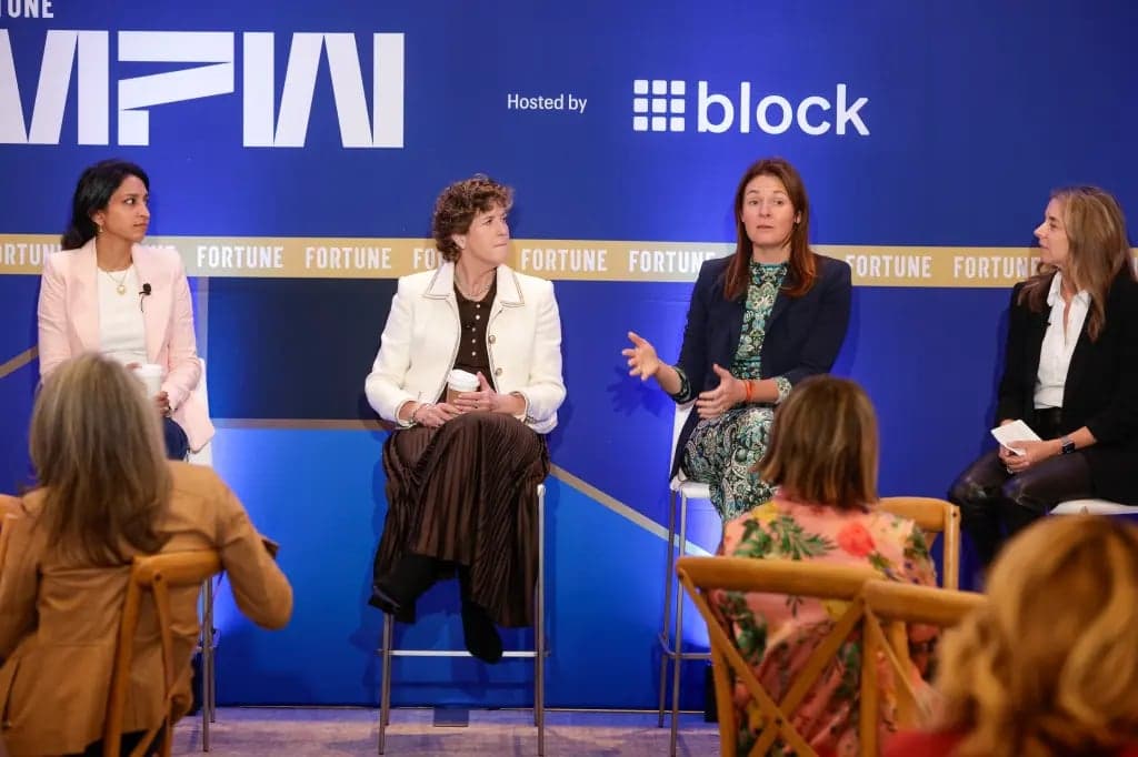 Four women seated on stage in front of a blue Fortune MPW backdrop hosted by Block, one gesturing mid conversation
