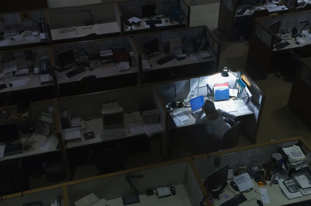 An office cubicle lit at night