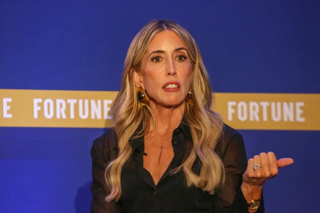 Gina Mastantuono speaking and gesturing on stage in front of a blue Fortune backdrop